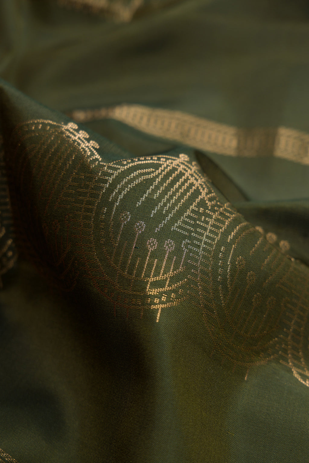 Close up of Mehandi Green Dual Tone Soft Silk Saree with Stripes on the body and Without Border.  displaying folds