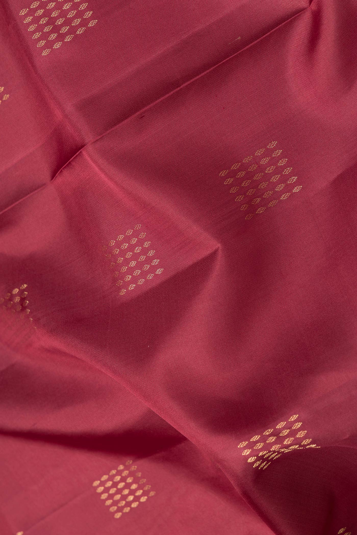 Close up of Maroon Dual Tone Soft Silk Saree with Zari Butta on the body and Zari Border.  displaying folds