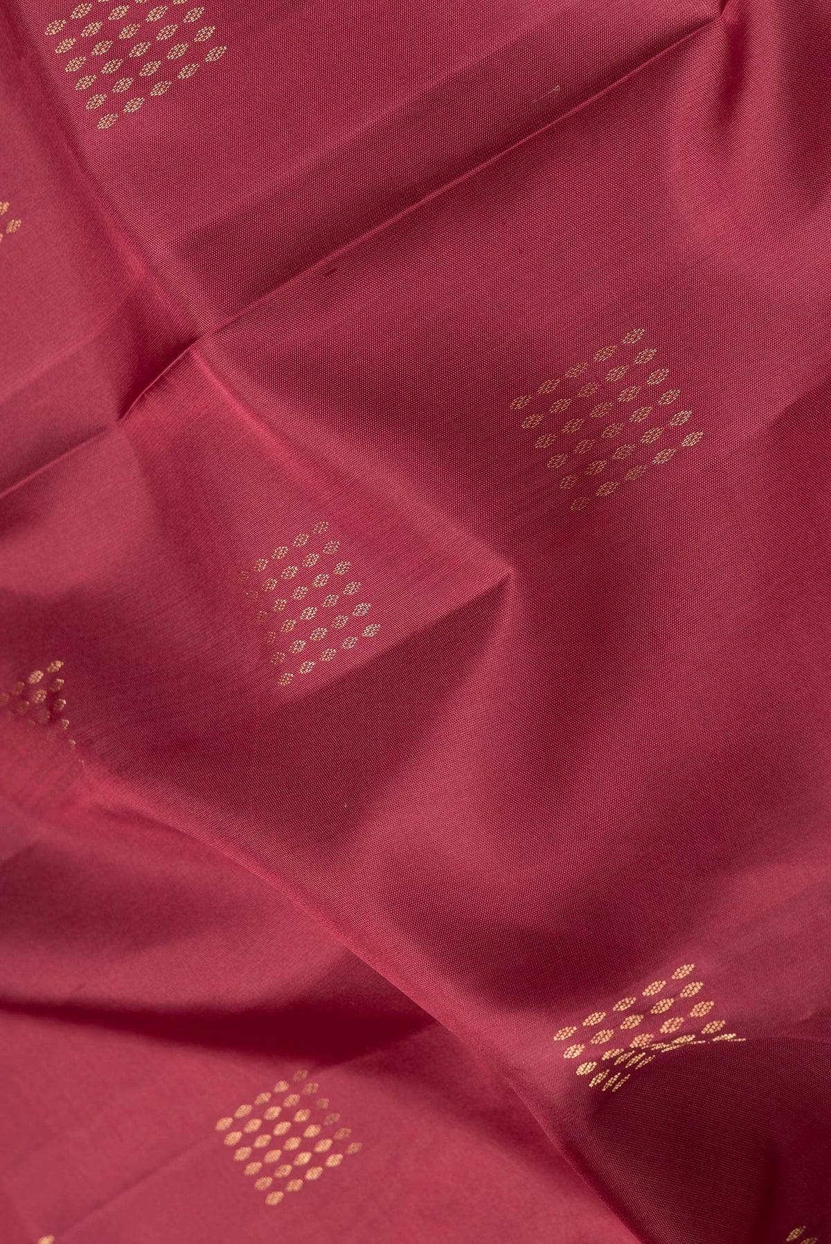 Close up of Maroon Dual Tone Soft Silk Saree with Zari Butta on the body and Zari Border.  displaying folds