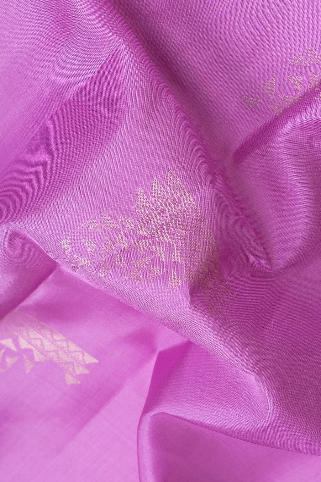 Close up of Lavender Dual Tone Soft Silk Saree with Zari Butta on the body and Zari Border.  displaying folds