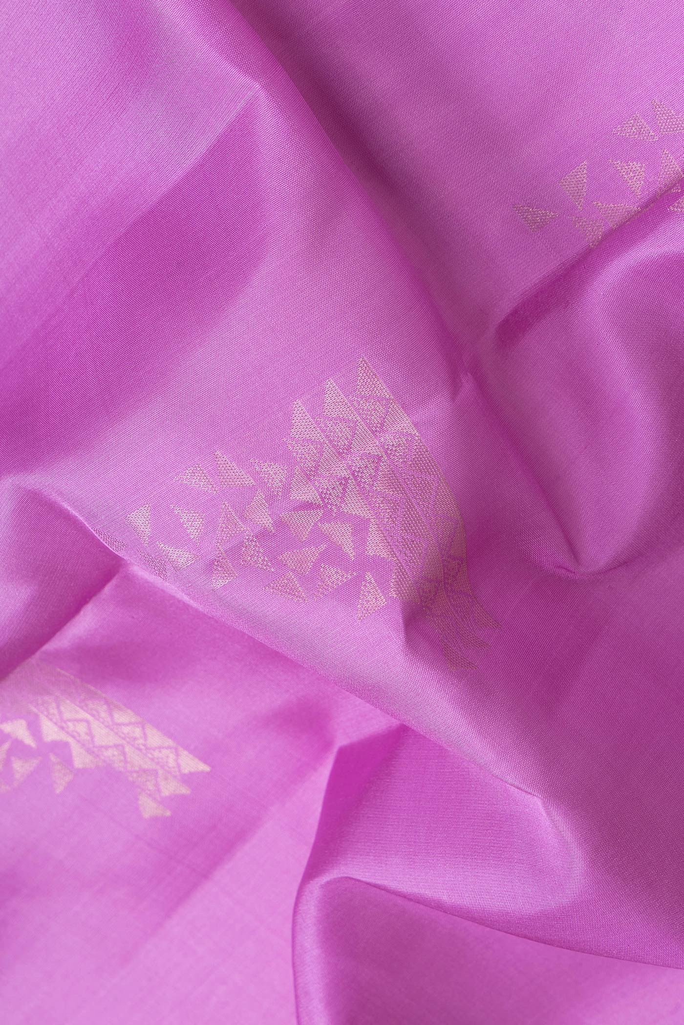 Close up of Lavender Dual Tone Soft Silk Saree with Zari Butta on the body and Zari Border.  displaying folds