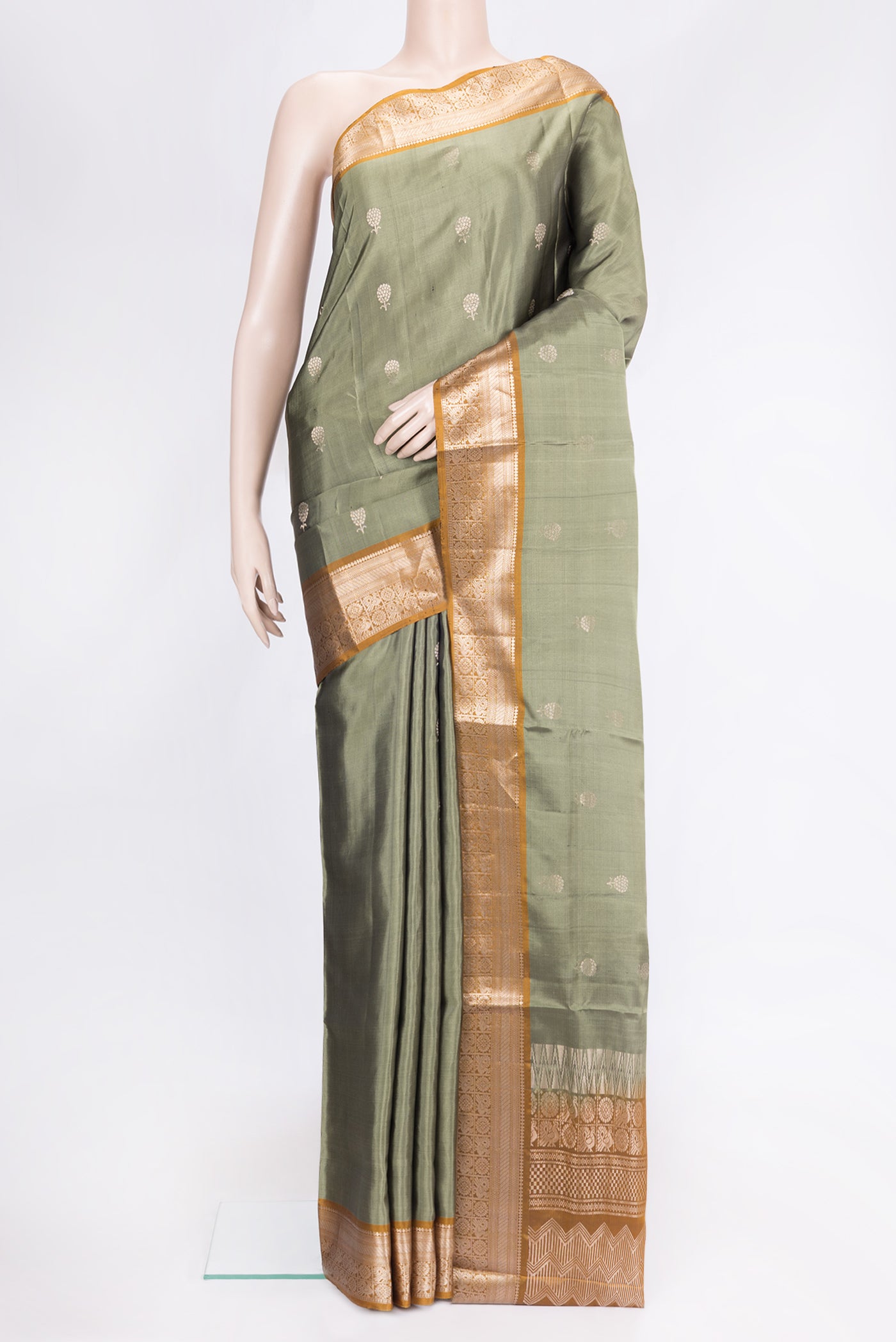 Mehandi Green Dual Tone Soft Silk Saree with Zari Butta on the body and Zari Border.  displayed on a mannequin