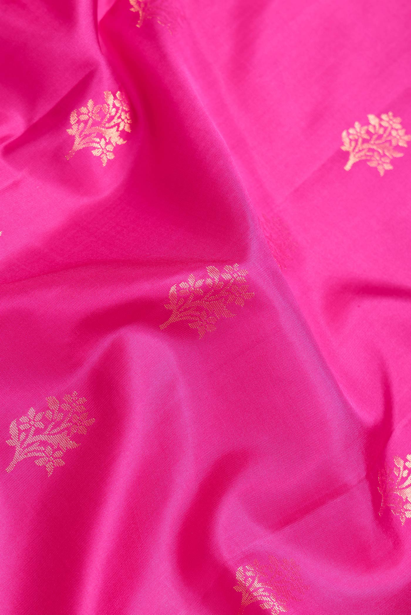 Close up of Pink Dual Tone Soft Silk Saree with Zari Butta on the body and Zari Border.  displaying folds
