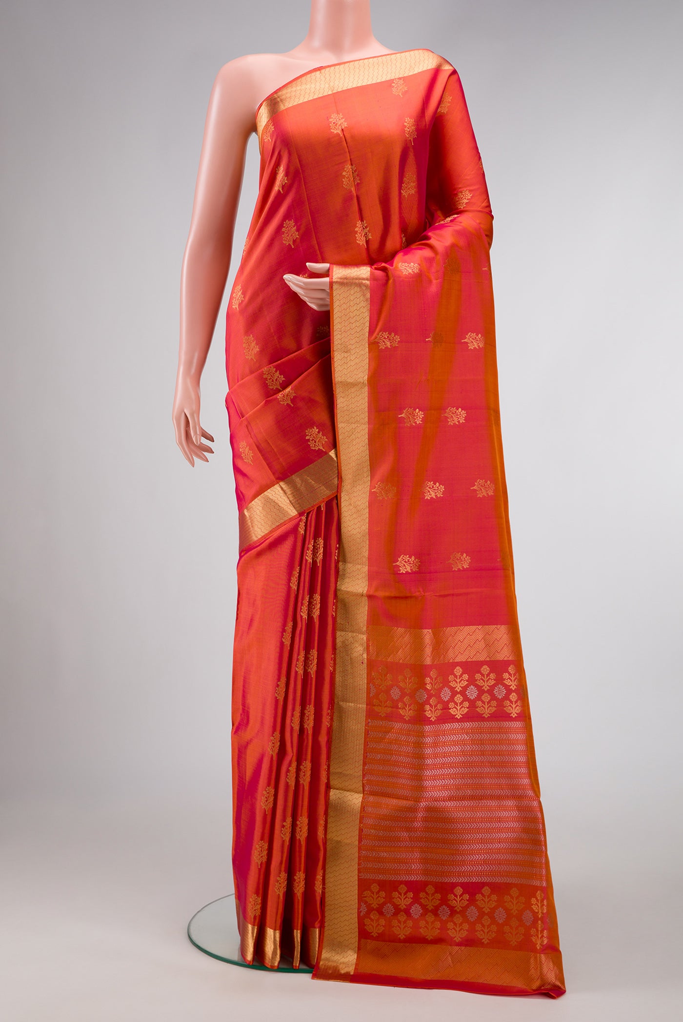 Brick Orange Dual Tone Soft Silk Saree with Zari Butta on the body and Zari Border.  displayed on a mannequin