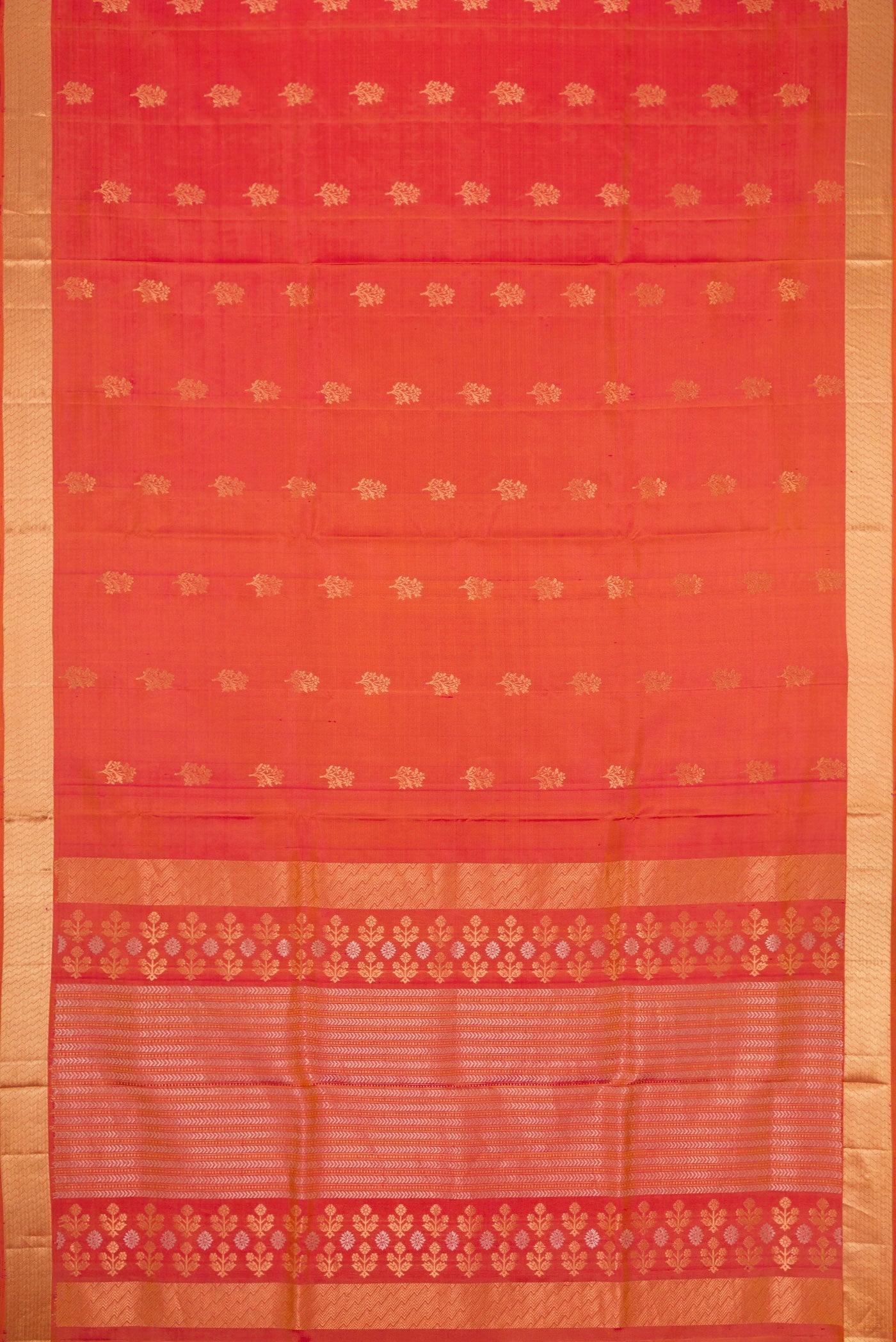 Flat view of Brick Orange Dual Tone Soft Silk Saree with Zari Butta on the body and Zari Border. 