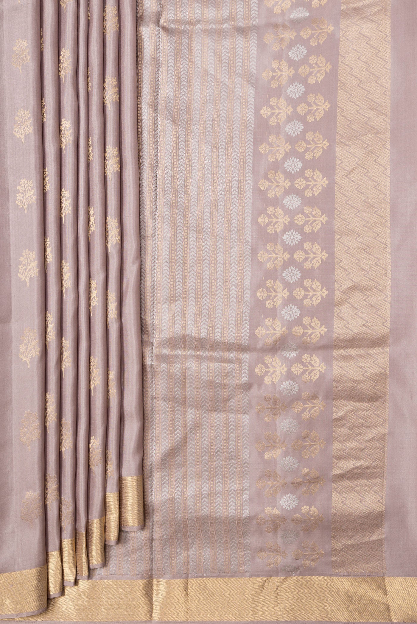 Pleats and pallu of Beige Dual Tone Soft Silk Saree with Zari Butta on the body and Zari Border. 