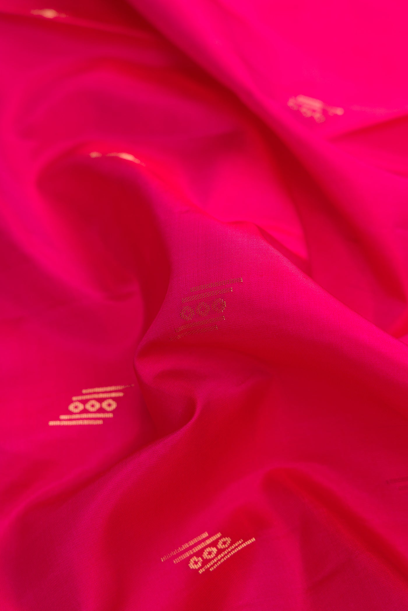 Close up of Pink Dual Tone Soft Silk Saree with Zari Butta on the body and Zari Border.  displaying folds