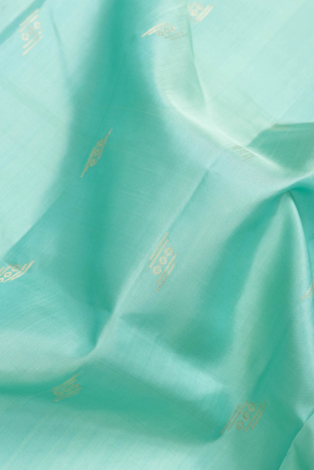 Close up of Sea Green Dual Tone Soft Silk Saree with Zari Butta on the body and Zari Border.  displaying folds