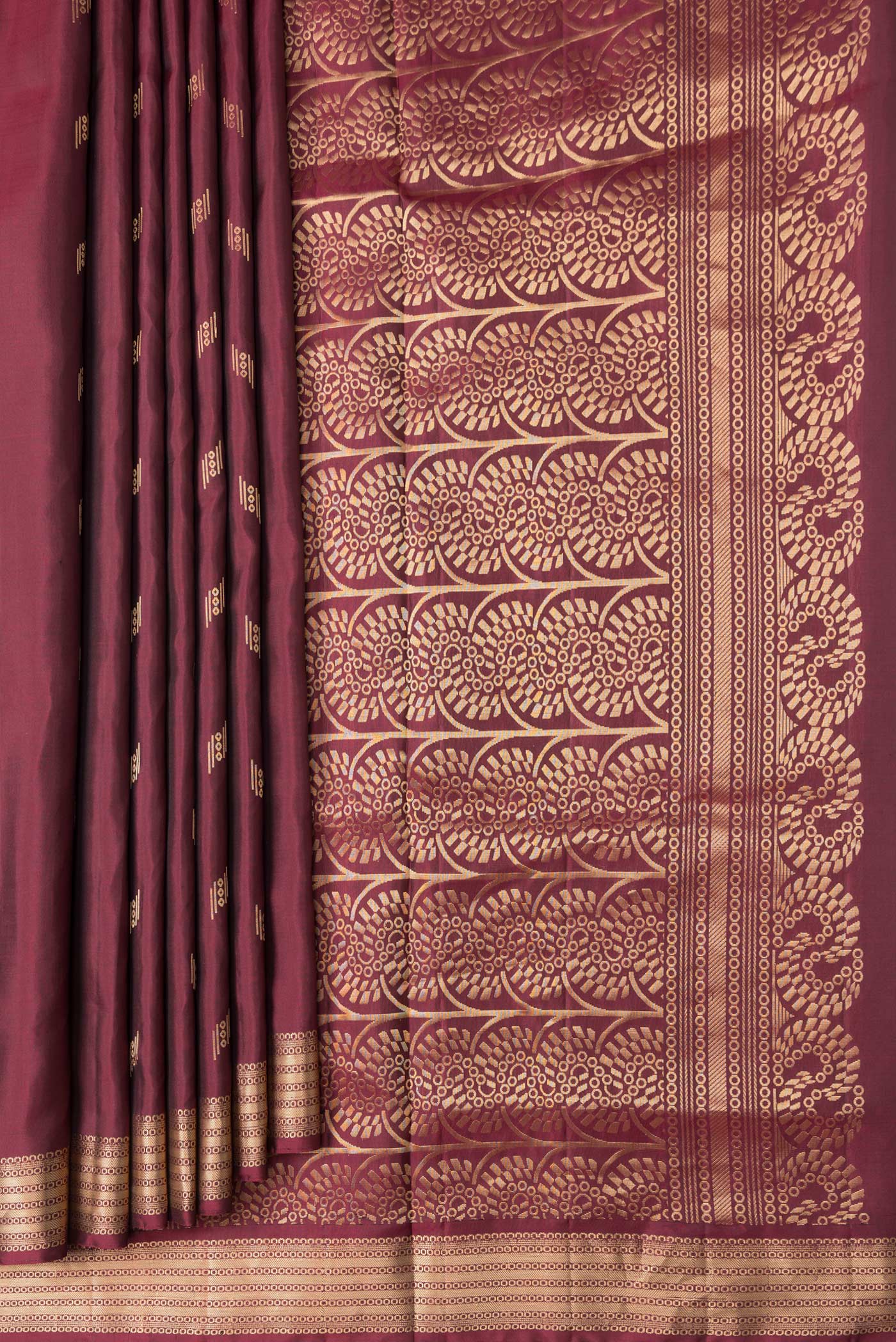 Pleats and pallu of Maroon Dual Tone Soft Silk Saree with Zari Butta on the body and Zari Border. 