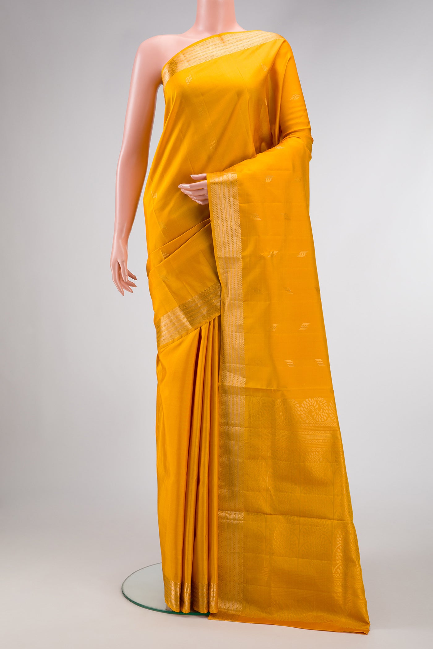 Mustard Dual Tone Soft Silk Saree with Zari Butta on the body and Zari Border.  displayed on a mannequin