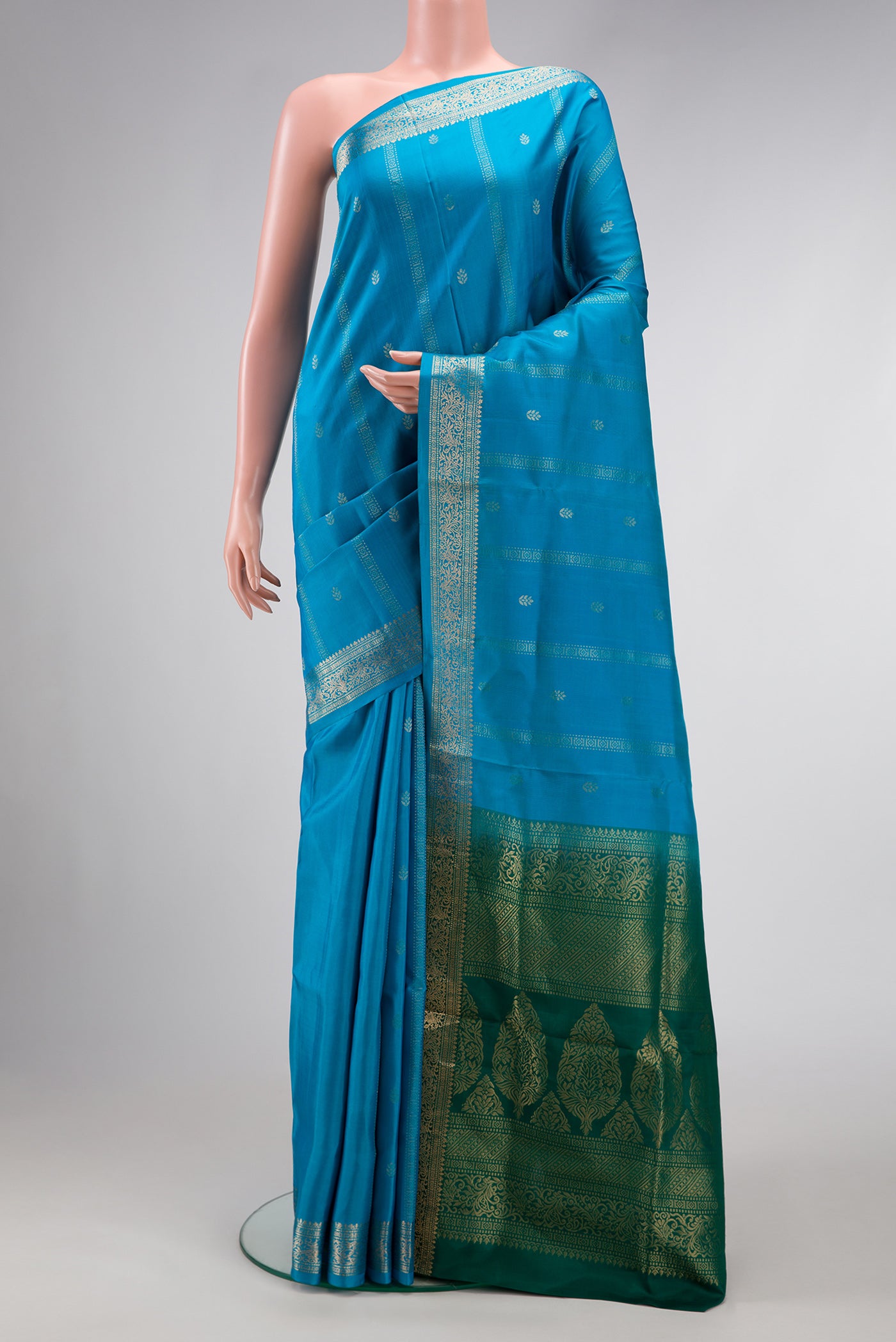 Sky Blue Dual Tone Soft Silk Saree with Zari Butta on the body and Zari Border.  displayed on a mannequin