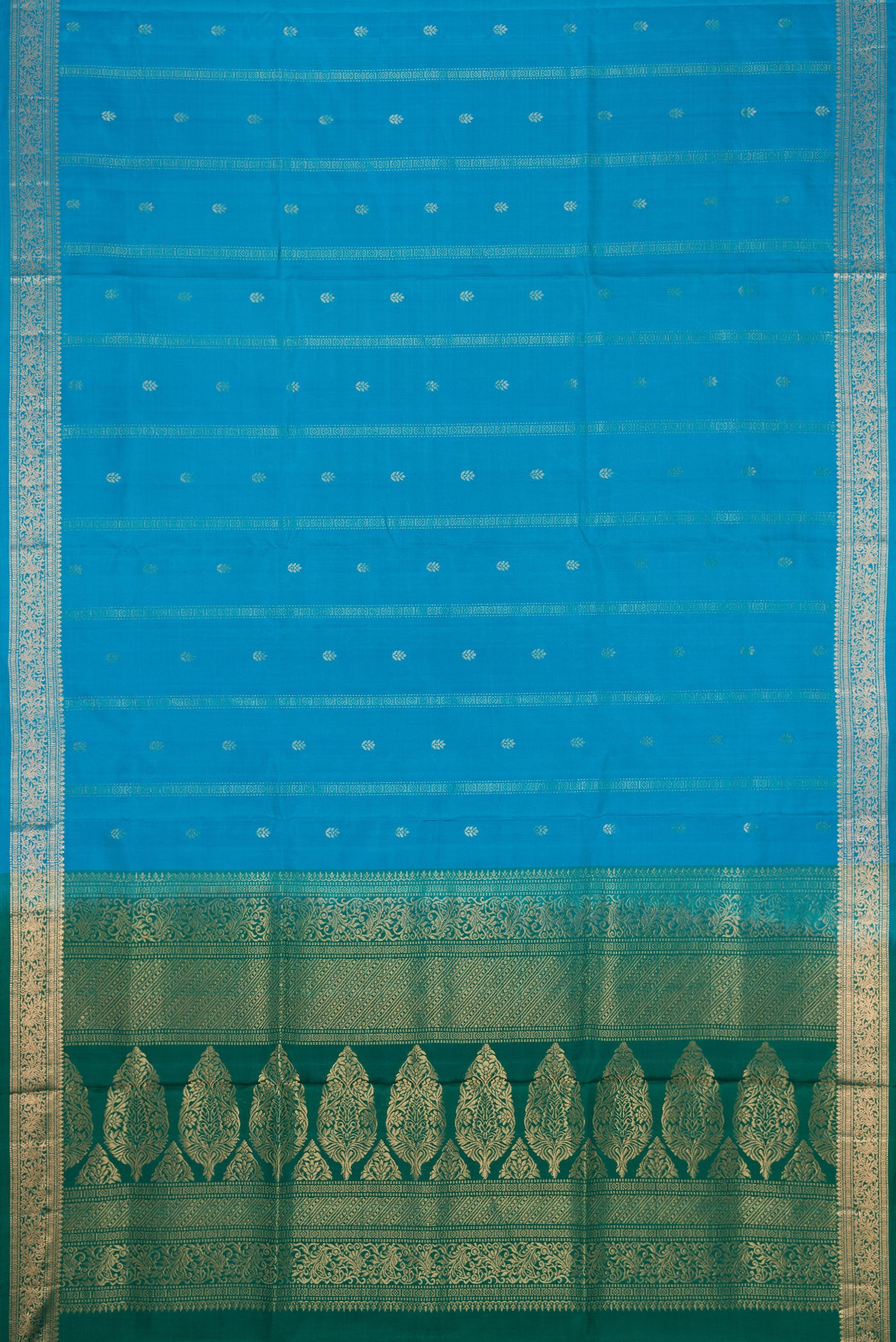 Flat view of Sky Blue Dual Tone Soft Silk Saree with Zari Butta on the body and Zari Border. 