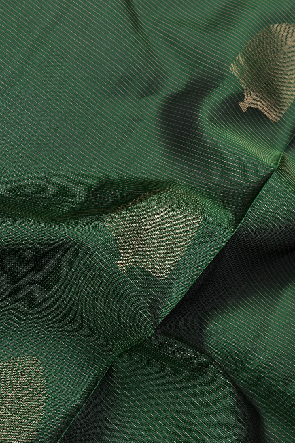 Close up of Bottle Green Dual Tone Soft Silk Saree with Stripes on the body and Without Border.  displaying folds