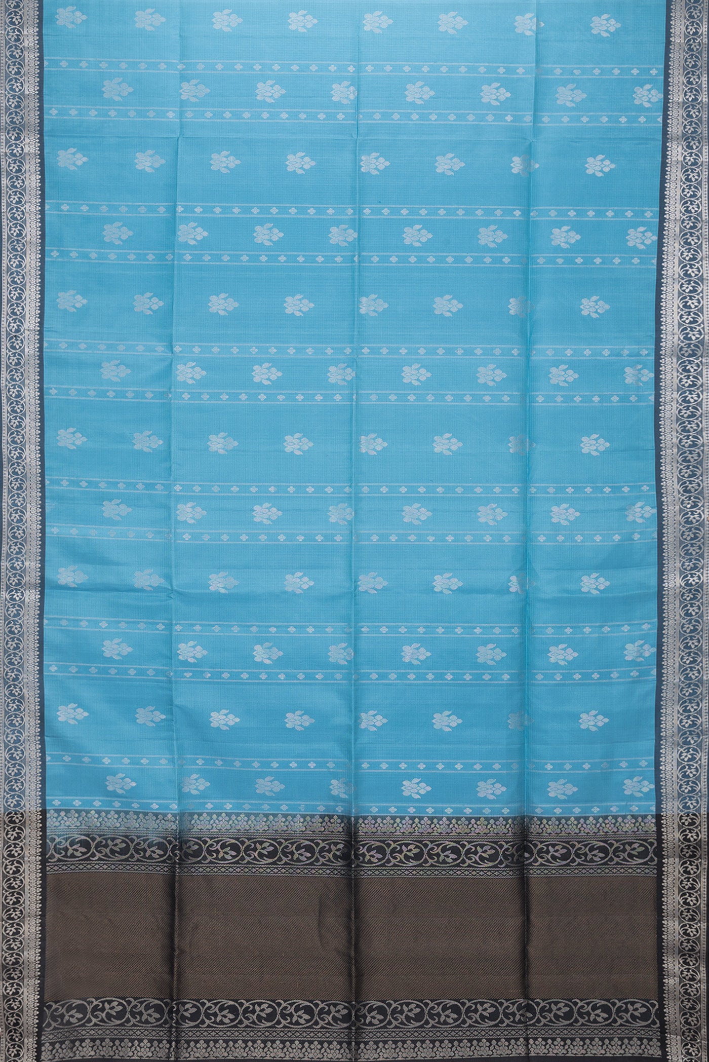 Flat view of Sky Blue Dual Tone Soft Silk Saree with Zari Butta on the body and Zari Border. 