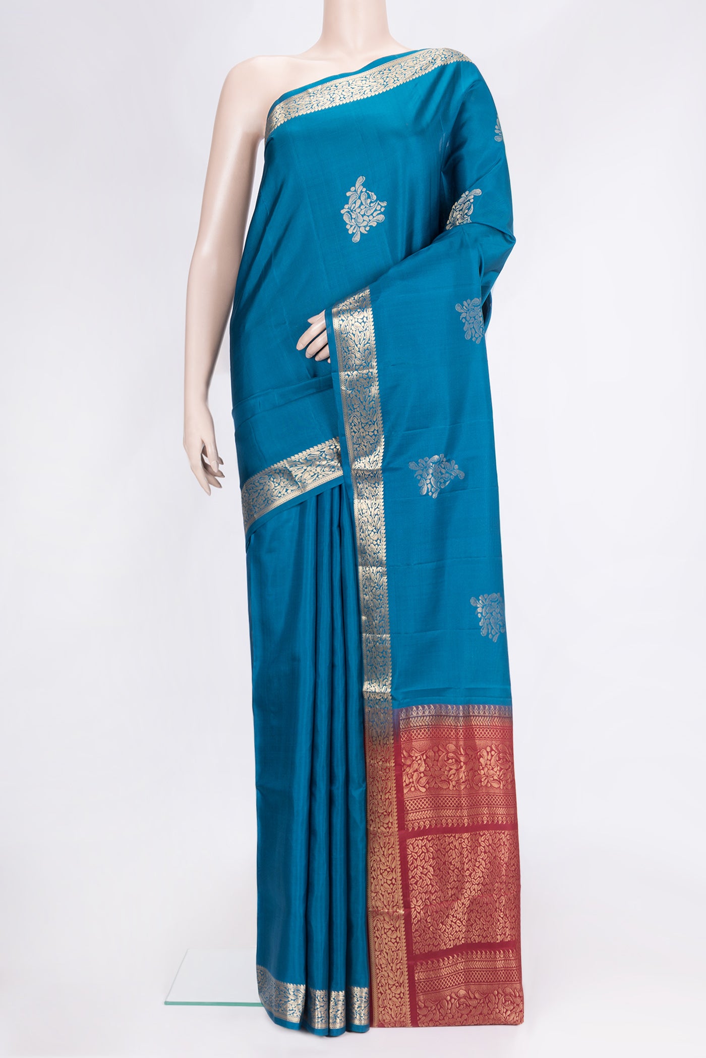 Peacock Blue Dual Tone Soft Silk Saree with Zari Butta on the body and Zari Border.  displayed on a mannequin