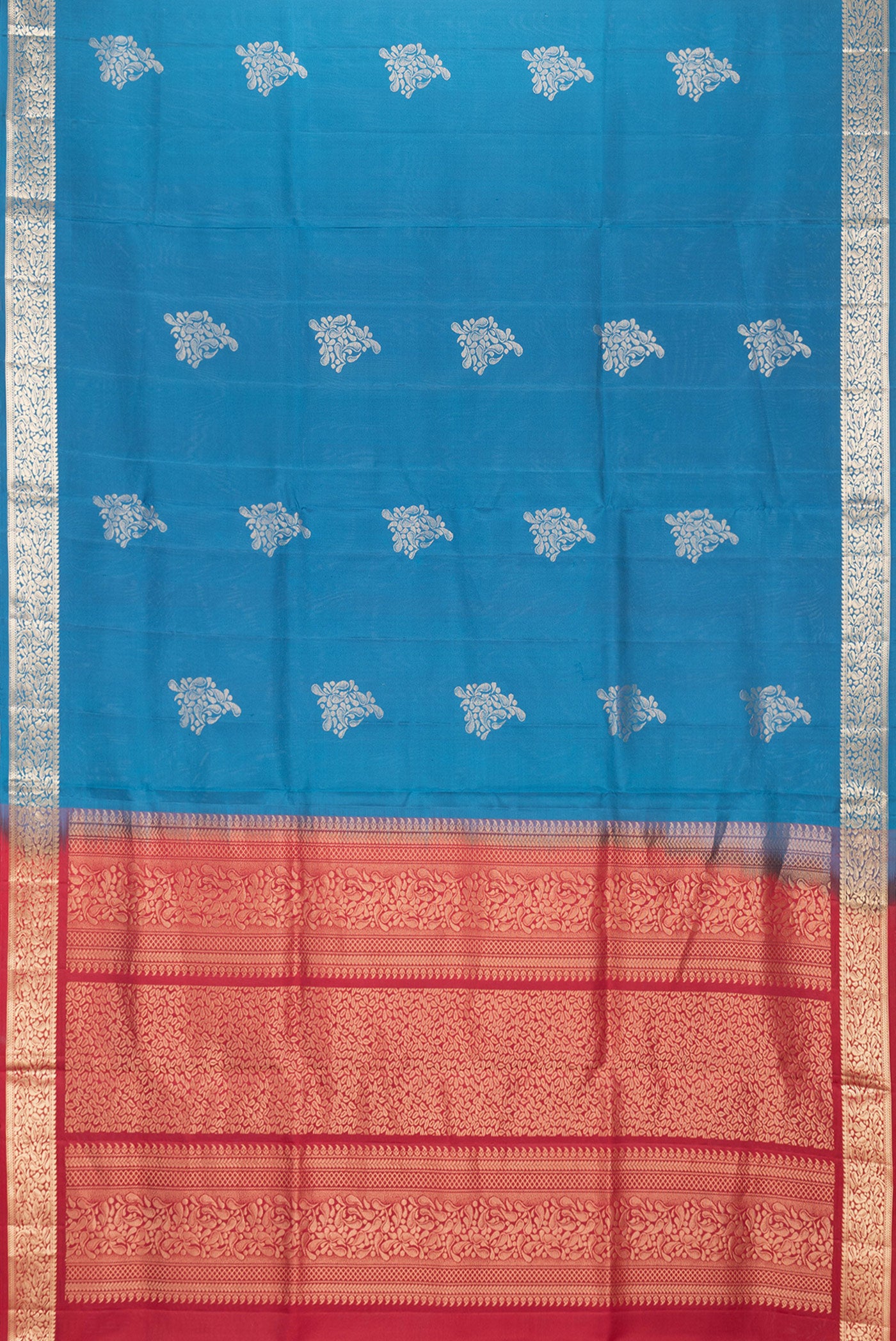Flat view of Peacock Blue Dual Tone Soft Silk Saree with Zari Butta on the body and Zari Border. 