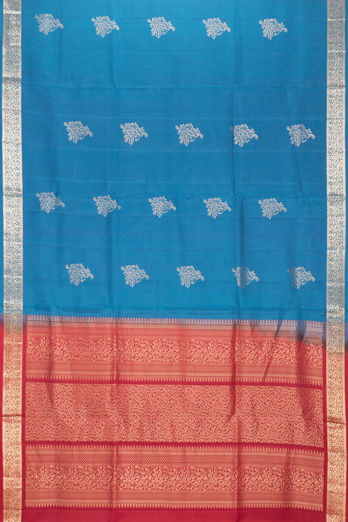 Flat view of Peacock Blue Dual Tone Soft Silk Saree with Zari Butta on the body and Zari Border. 