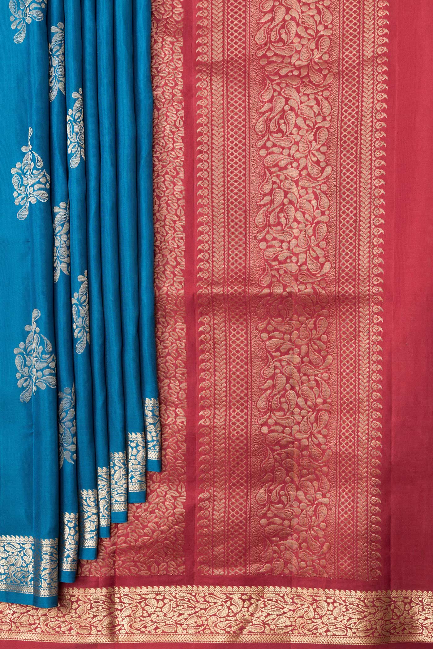 Pleats and pallu of Peacock Blue Dual Tone Soft Silk Saree with Zari Butta on the body and Zari Border. 