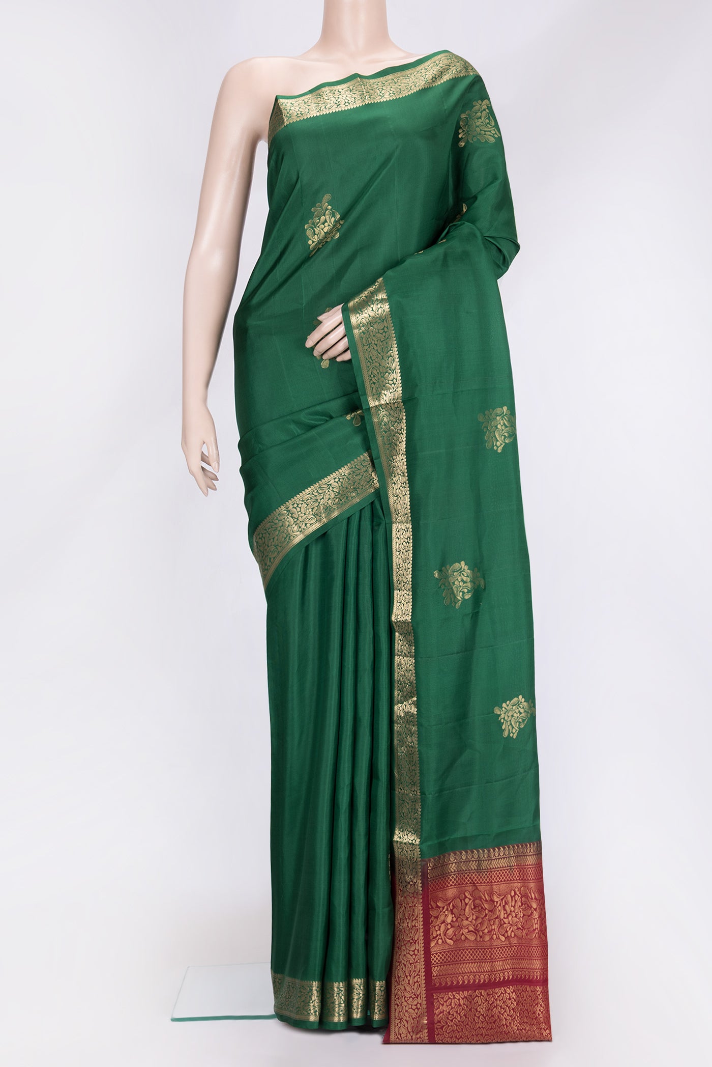 Bottle Green Dual Tone Soft Silk Saree with Zari Butta on the body and Zari Border.  displayed on a mannequin