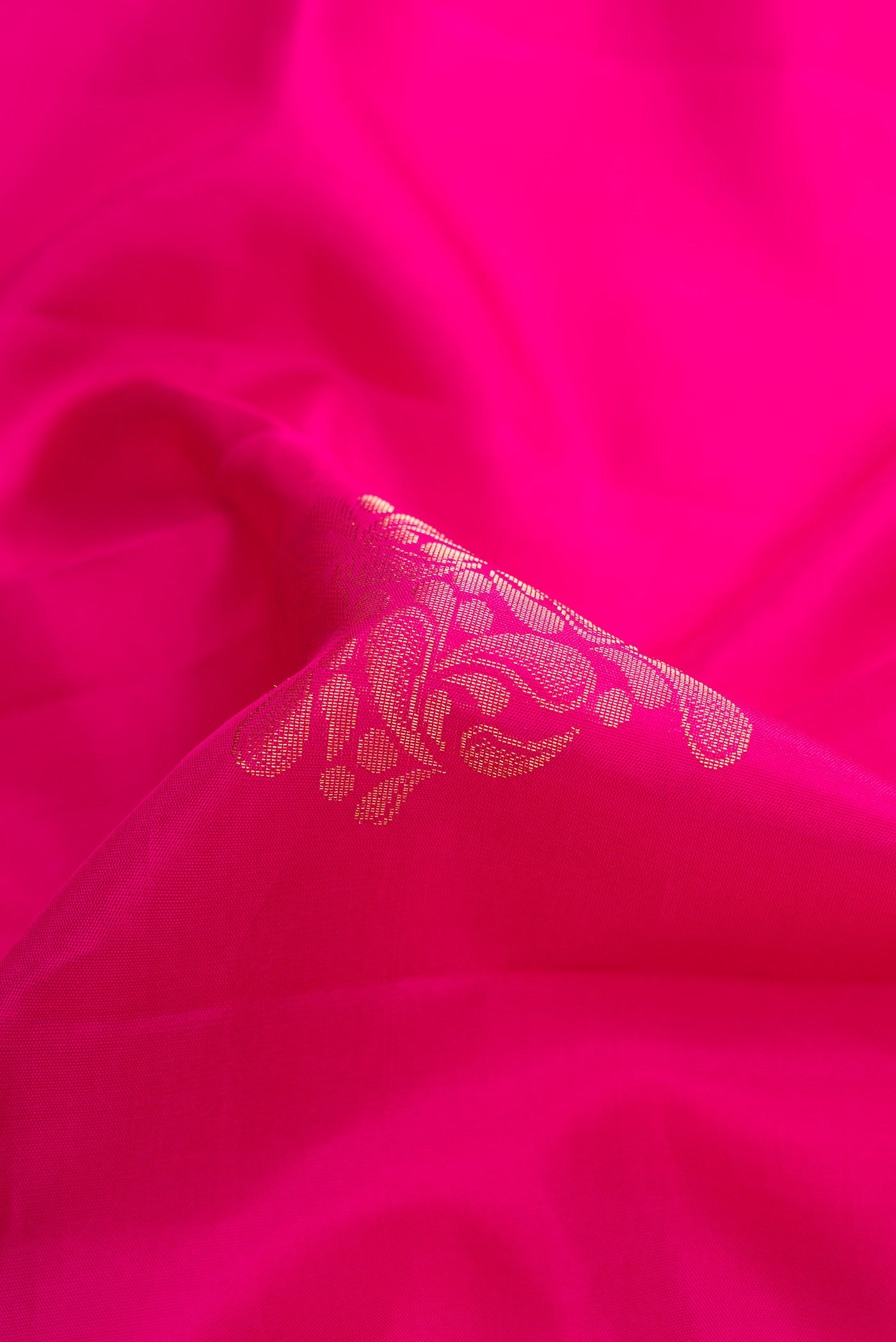 Close up of Pink Dual Tone Soft Silk Saree with Zari Butta on the body and Zari Border.  displaying folds