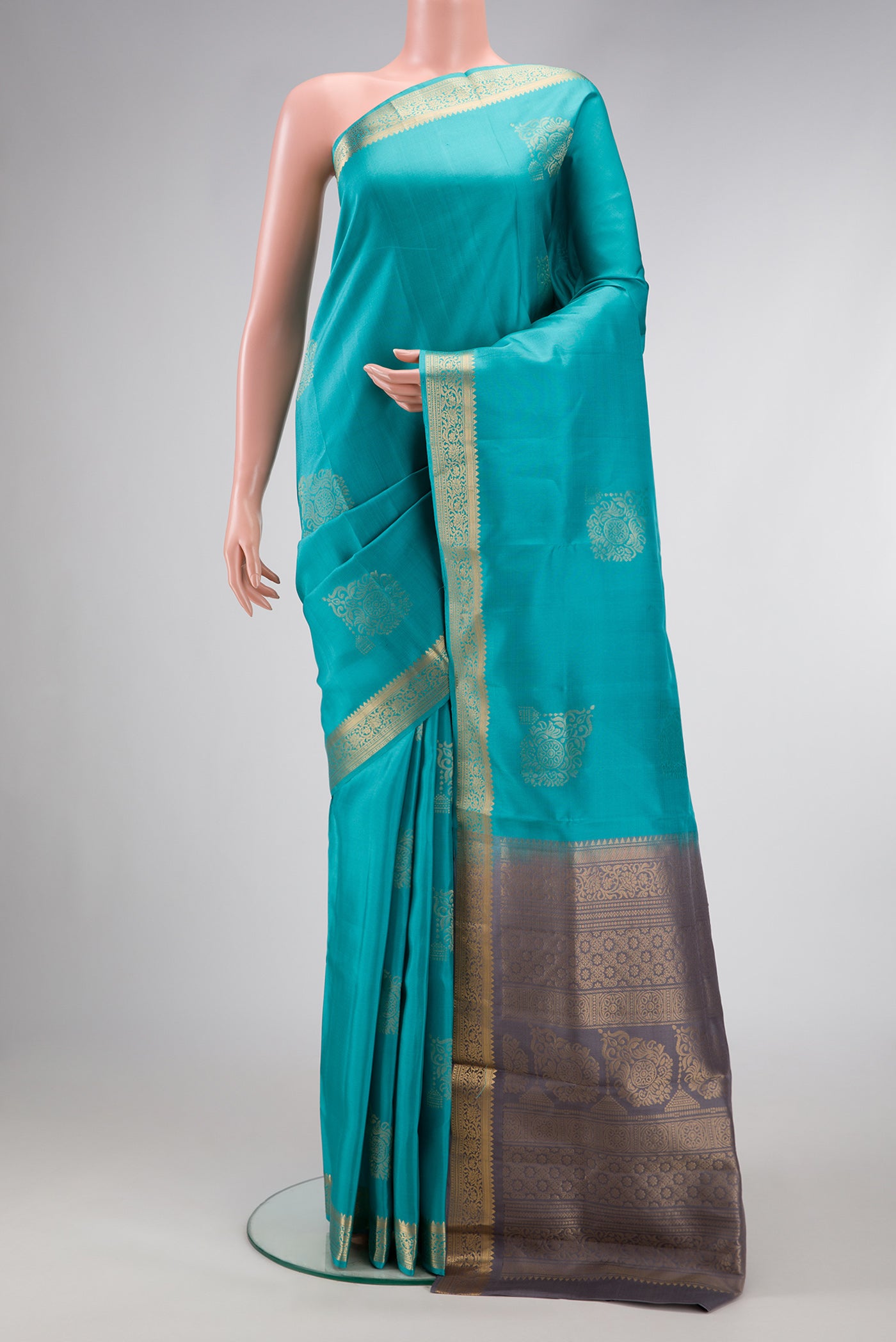 Light Blue Dual Tone Soft Silk Saree with Zari Butta on the body and Zari Border.  displayed on a mannequin