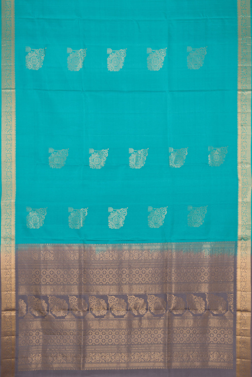 Flat view of Light Blue Dual Tone Soft Silk Saree with Zari Butta on the body and Zari Border. 