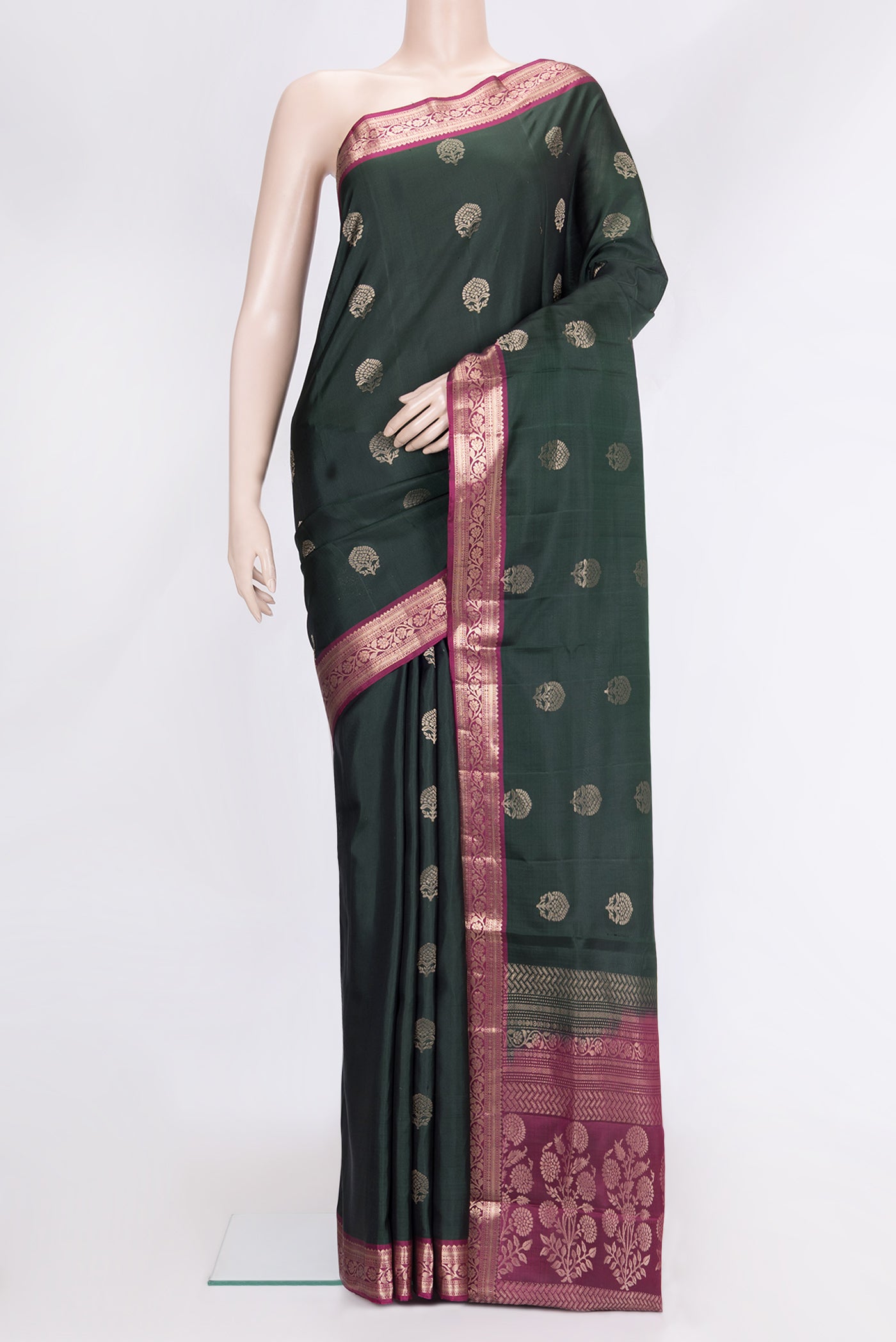 Bottle Green Dual Tone Soft Silk Saree with Zari Butta on the body and Zari Border.  displayed on a mannequin