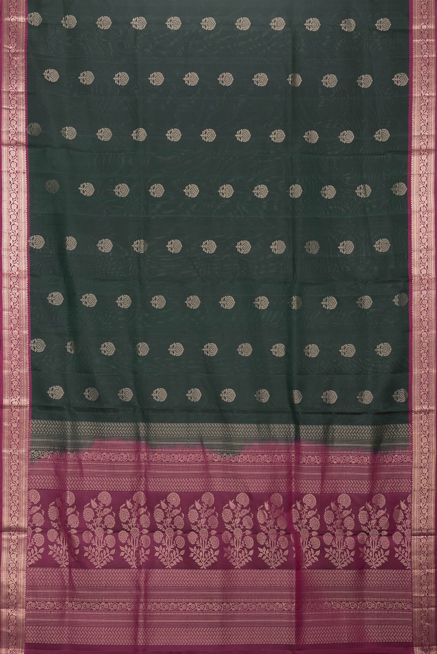 Flat view of Bottle Green Dual Tone Soft Silk Saree with Zari Butta on the body and Zari Border. 