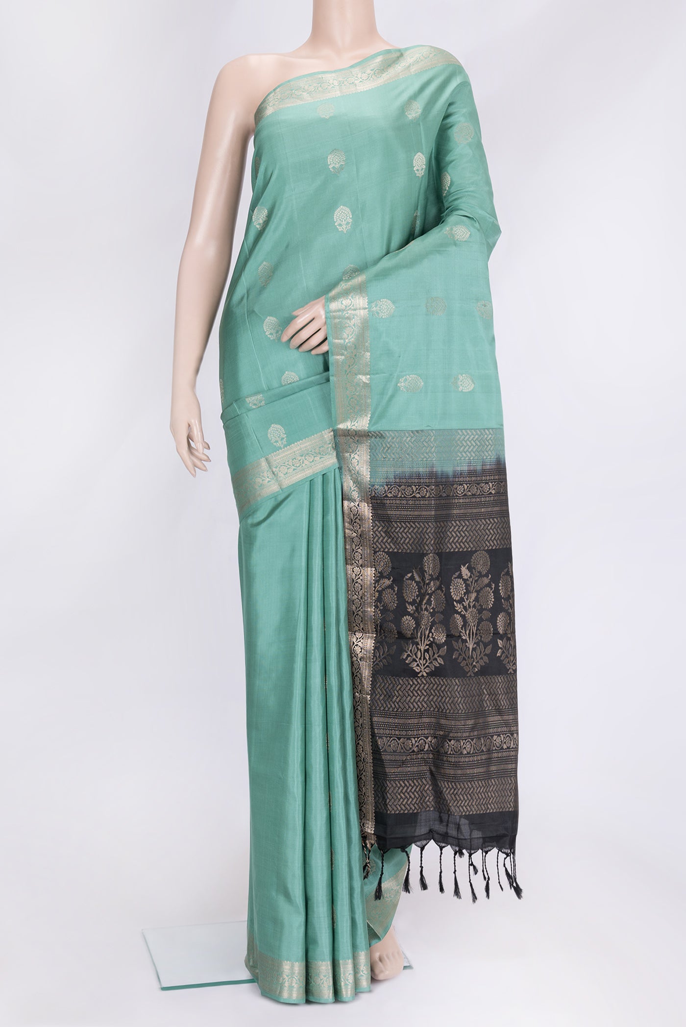 Sea Green Dual Tone Soft Silk Saree with Zari Butta on the body and Zari Border.  displayed on a mannequin