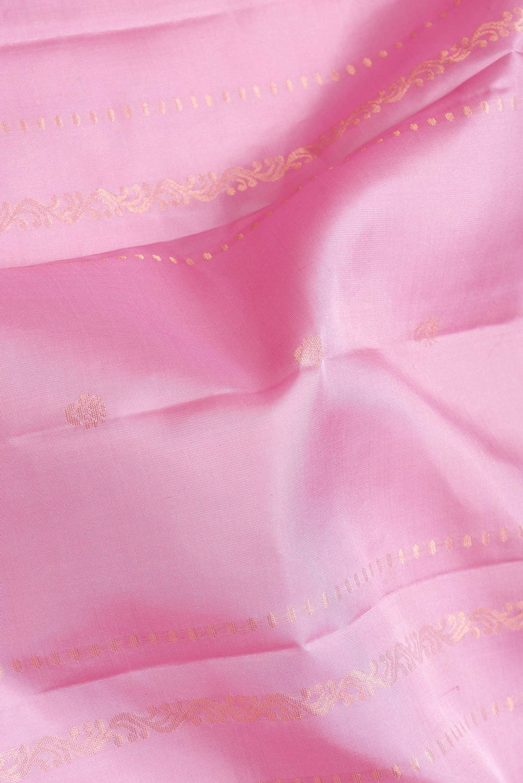 Close up of Pink Dual Tone Soft Silk Saree with Zari Butta on the body and Zari Border.  displaying folds