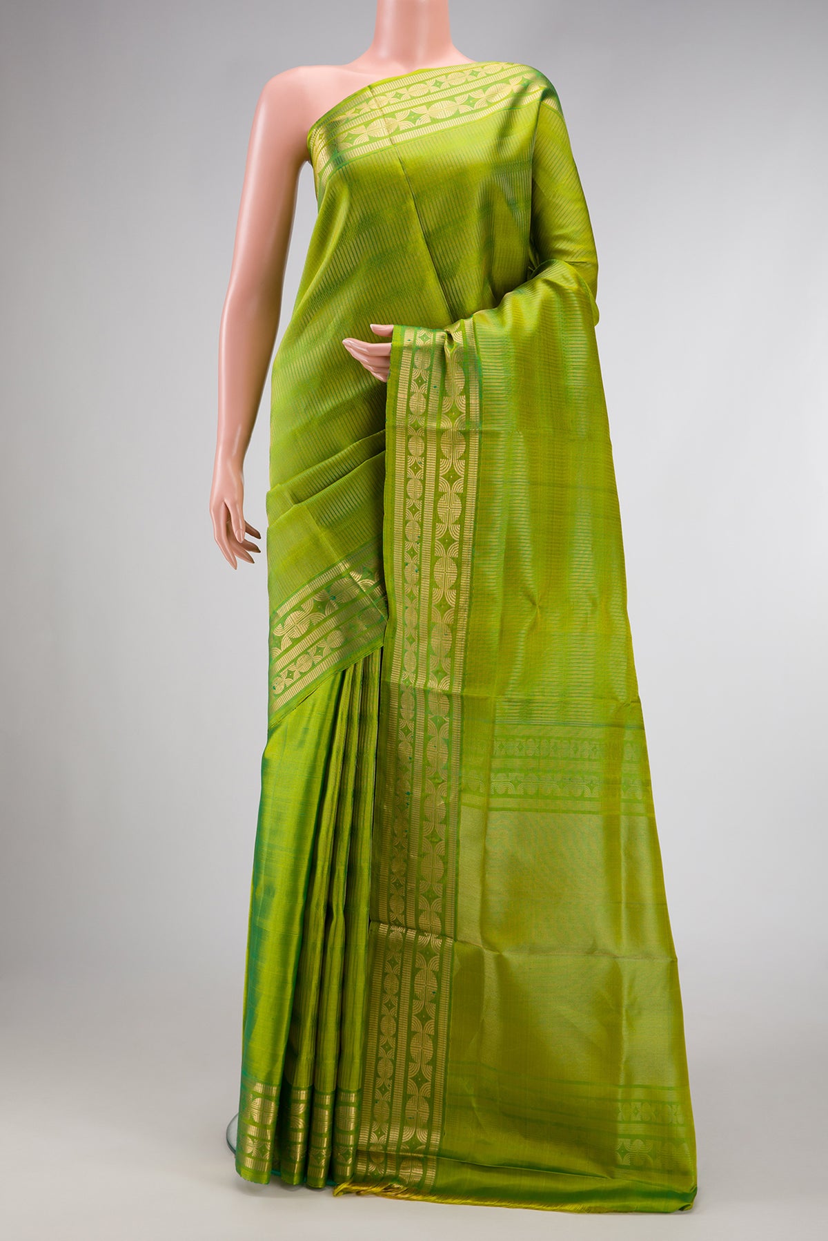 Green Dual Tone Soft Silk Saree with Zari Brocade on the body and Zari Border.  displayed on a mannequin