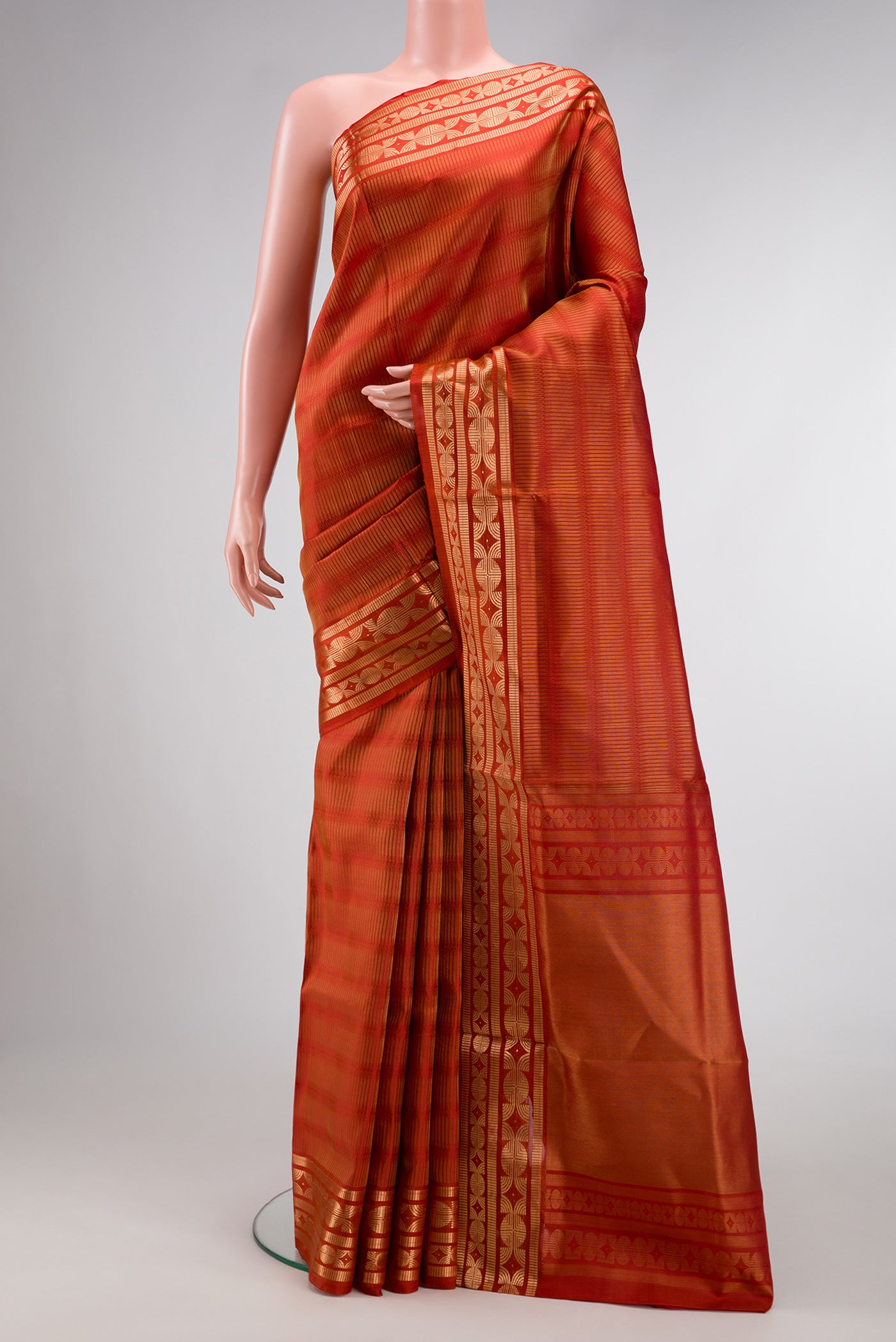 Brick Orange Dual Tone Soft Silk Saree with Zari Butta on the body and Zari Border.  displayed on a mannequin