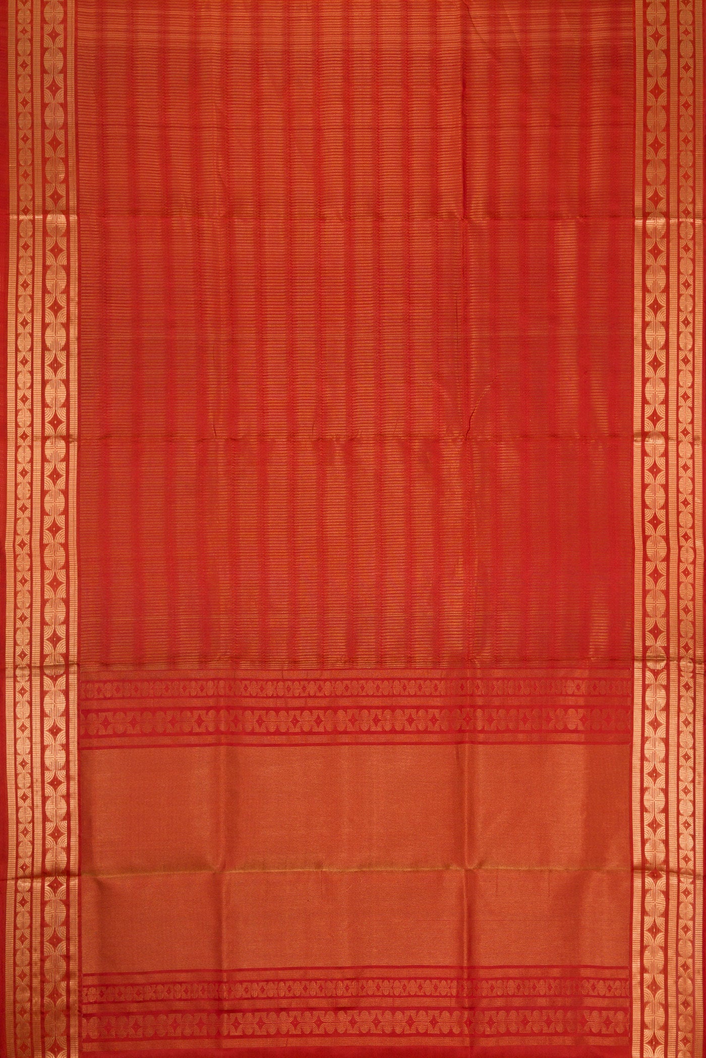 Flat view of Brick Orange Dual Tone Soft Silk Saree with Zari Butta on the body and Zari Border. 