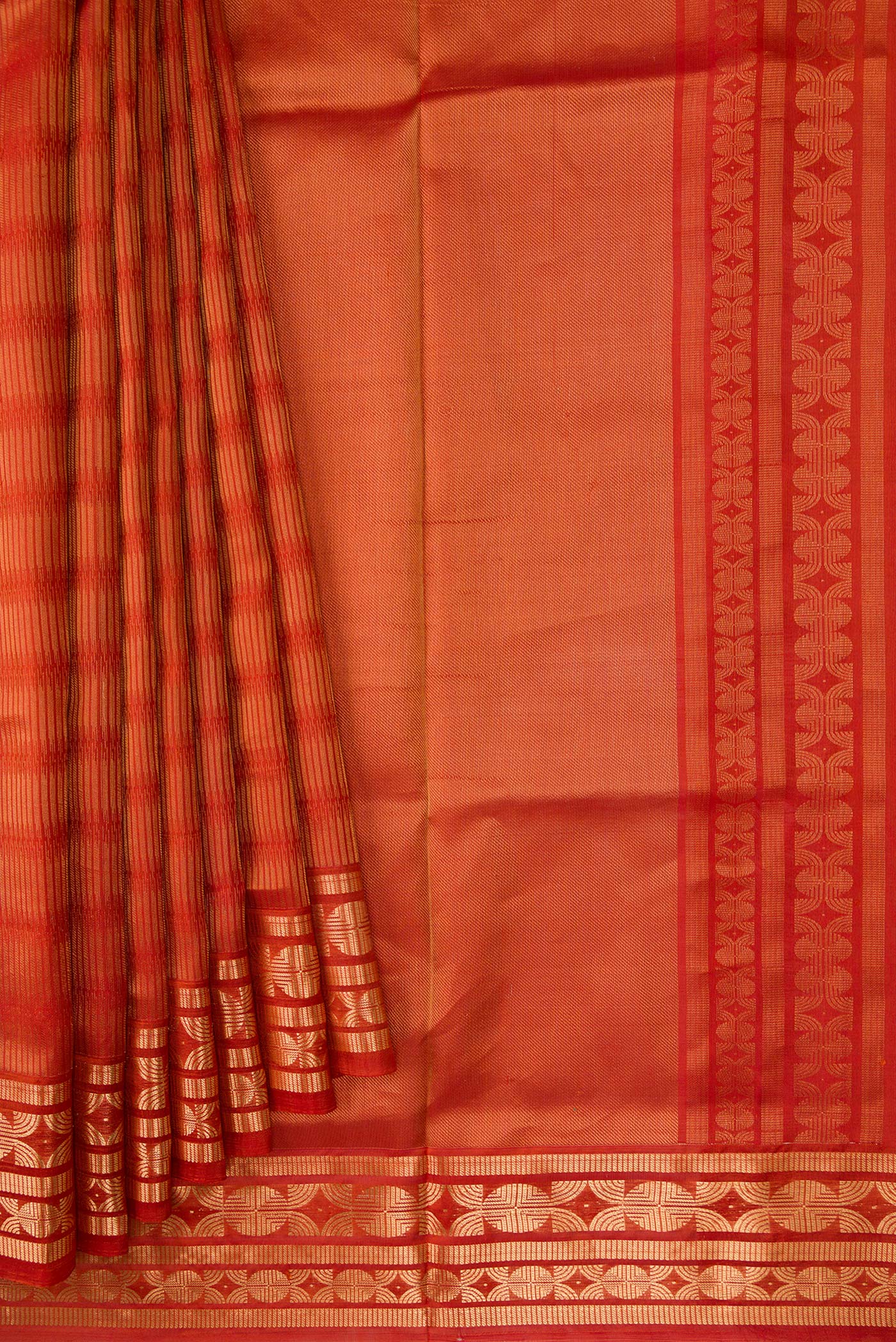 Pleats and pallu of Brick Orange Dual Tone Soft Silk Saree with Zari Butta on the body and Zari Border. 