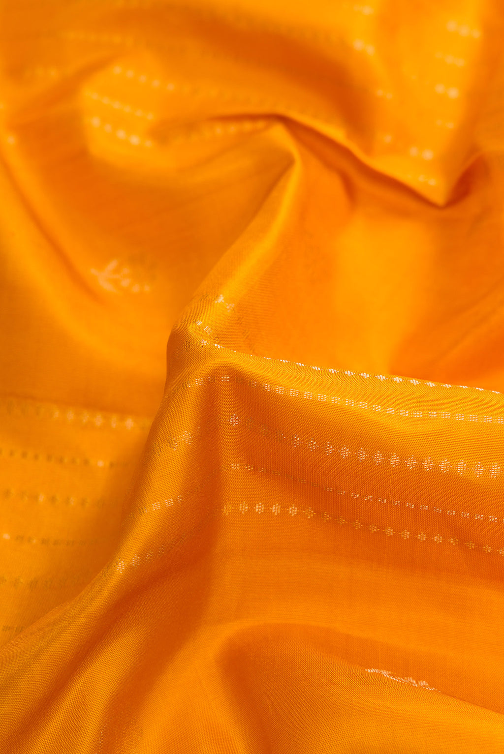 Close up of Mustard Dual Tone Soft Silk Saree with Stripes on the body and Zari Border.  displaying folds