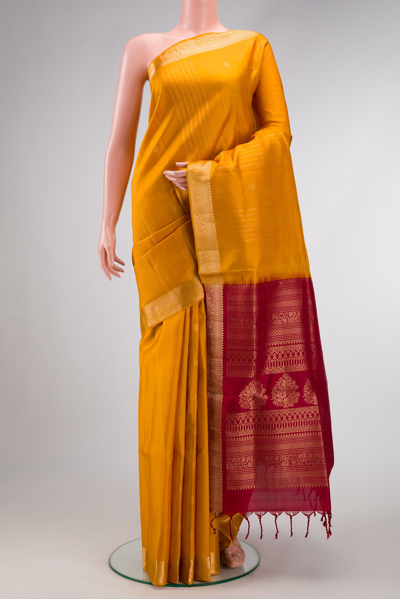 Mustard Dual Tone Soft Silk Saree with Stripes on the body and Zari Border.  displayed on a mannequin