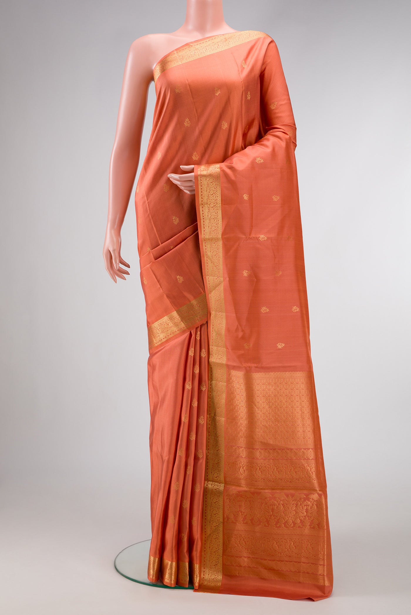 Golden Peach Dual Tone Soft Silk Saree with Zari Butta on the body and Zari Border.  displayed on a mannequin