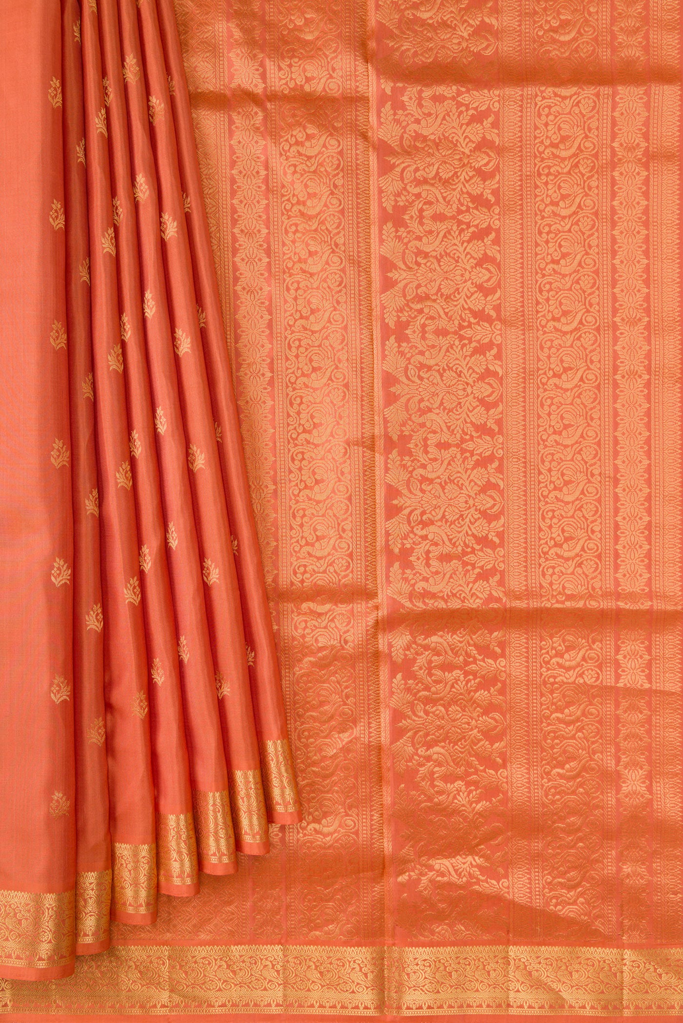 Pleats and pallu of Golden Peach Dual Tone Soft Silk Saree with Zari Butta on the body and Zari Border. 