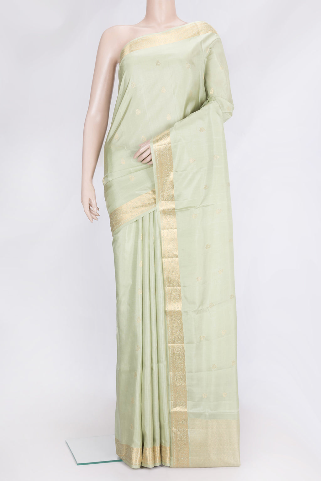 Pista Green Dual Tone Soft Silk Saree with Zari Butta on the body and Zari Border.  displayed on a mannequin