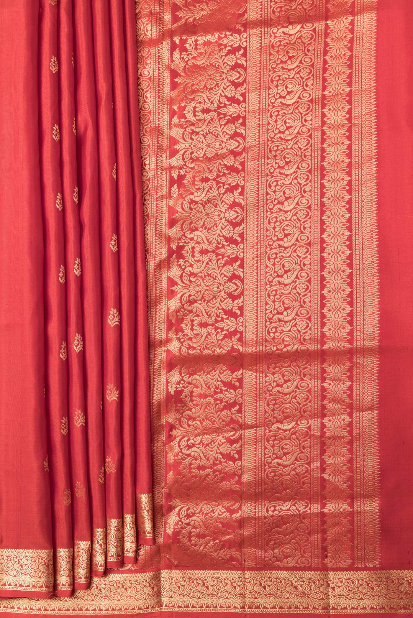 Pleats and pallu of Brick Orange Dual Tone Soft Silk Saree with Zari Butta on the body and Zari Border. 