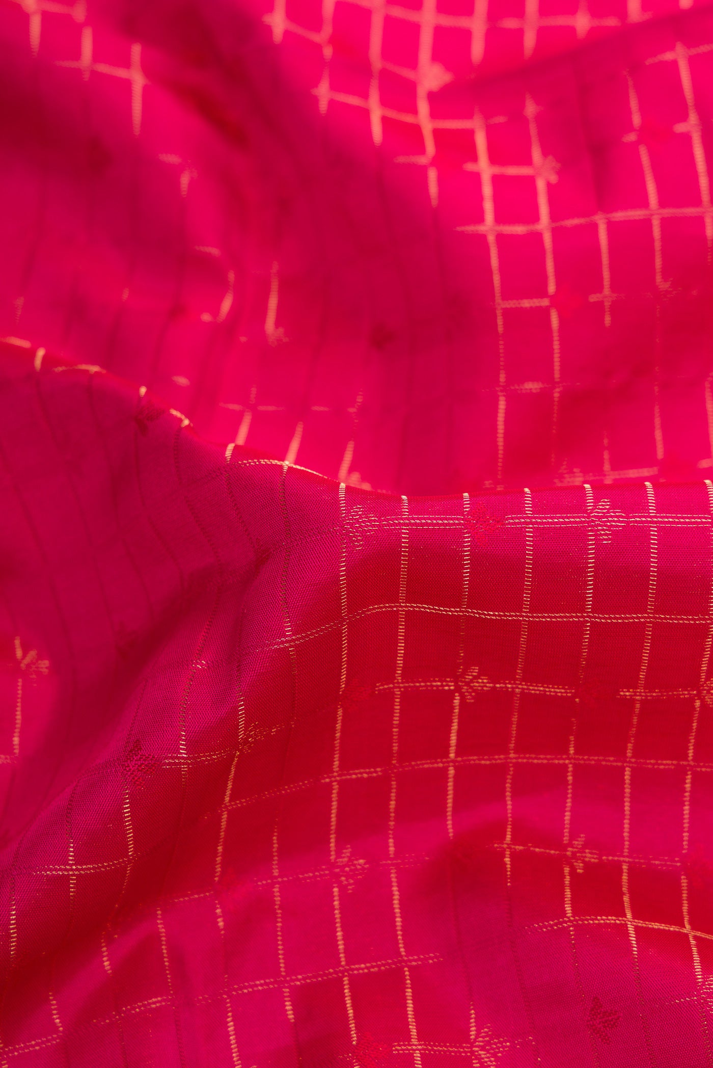 Close up of Dark Pink Dual Tone Soft Silk Saree with Checked design on the body and Zari Border.  displaying folds