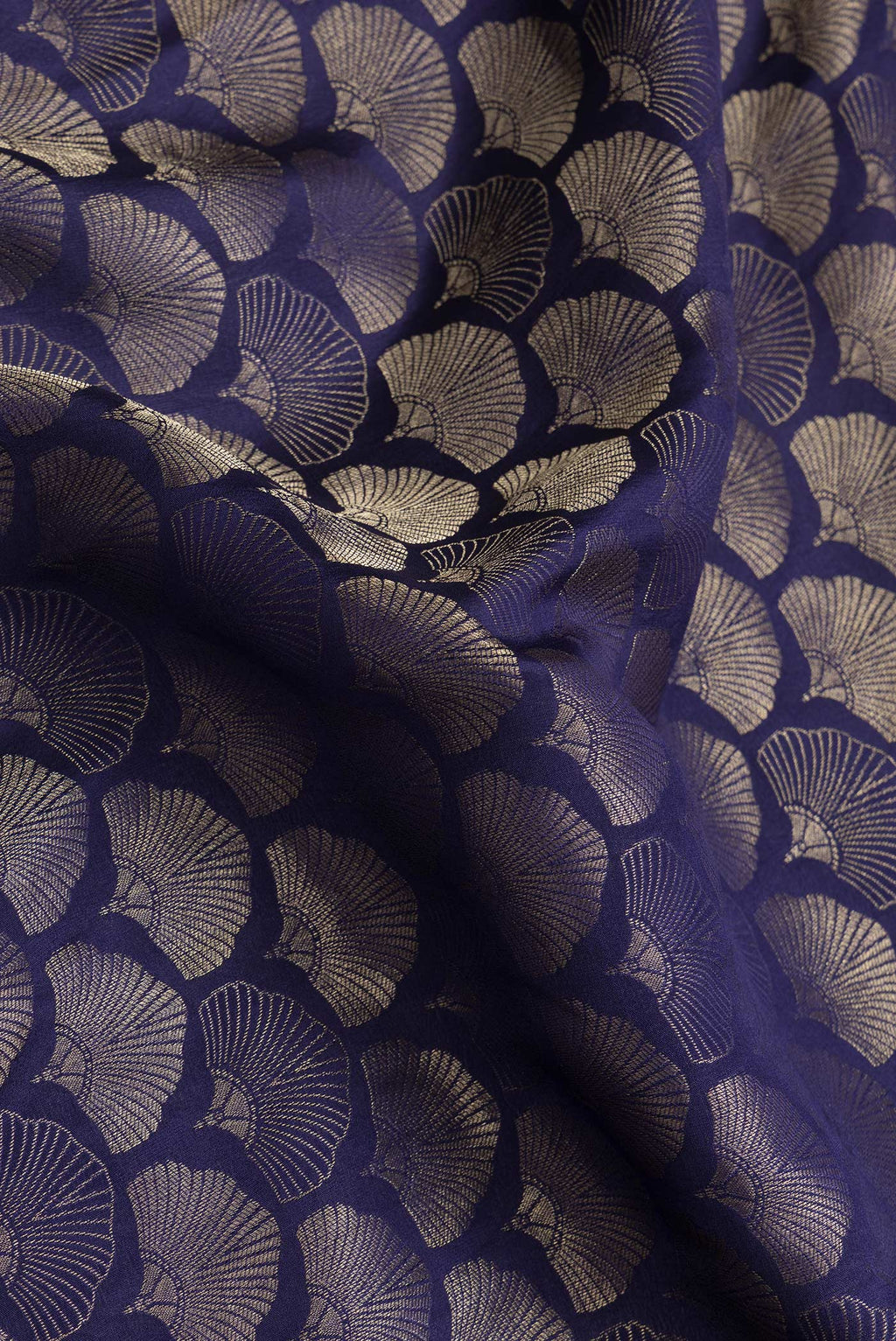 Close up of Navy Blue Dual Tone Tussar Silk Saree with Zari Brocade on the body and Zari Border.  displaying folds