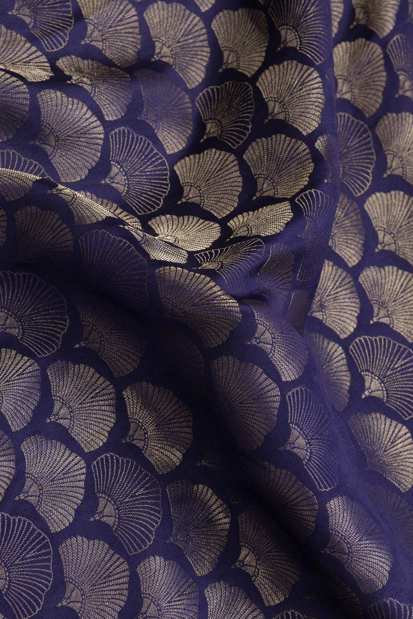 Close up of Navy Blue Dual Tone Tussar Silk Saree with Zari Brocade on the body and Zari Border.  displaying folds