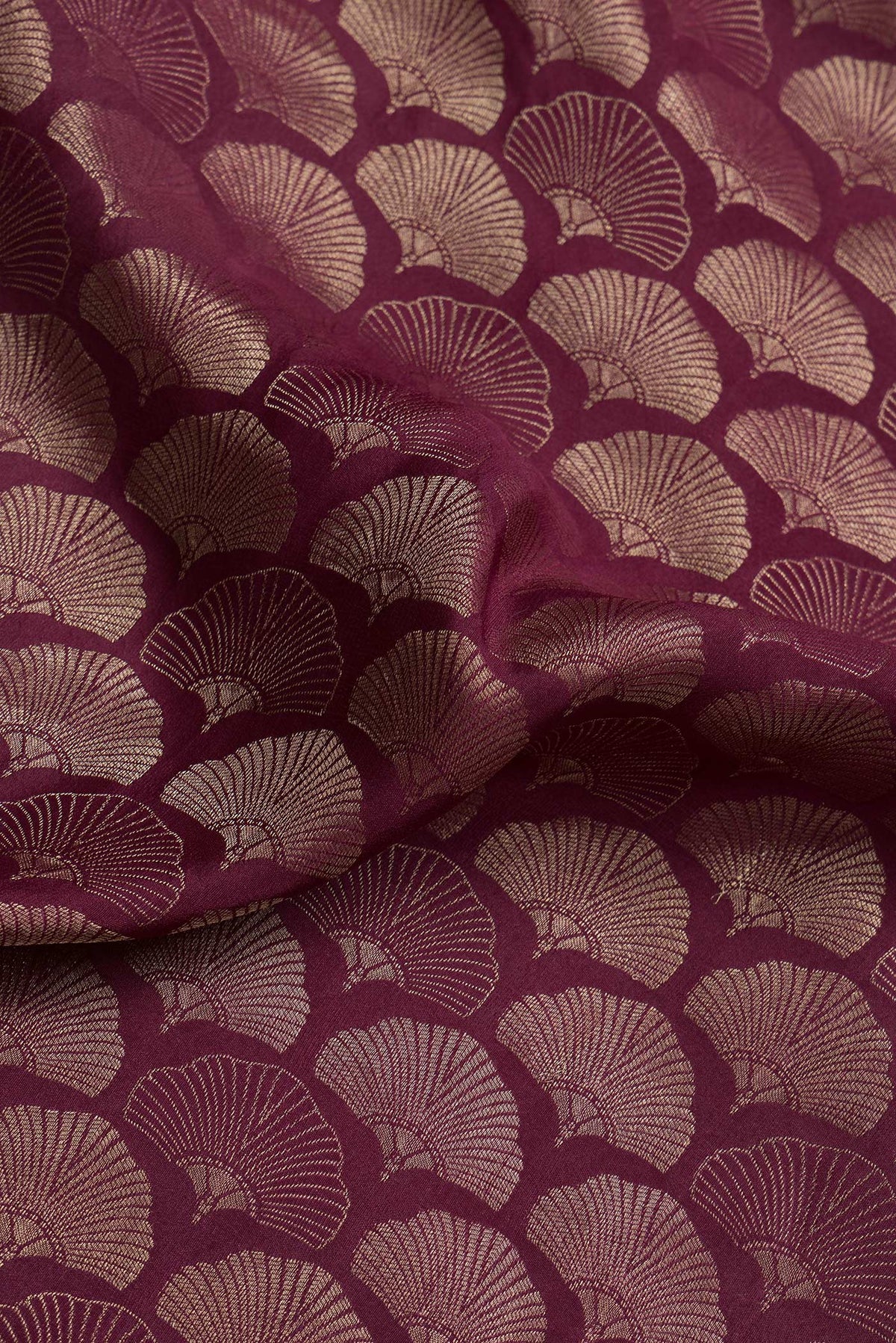 Close up of Maroon Dual Tone Tussar Silk Saree with Zari Brocade on the body and Zari Border.  displaying folds
