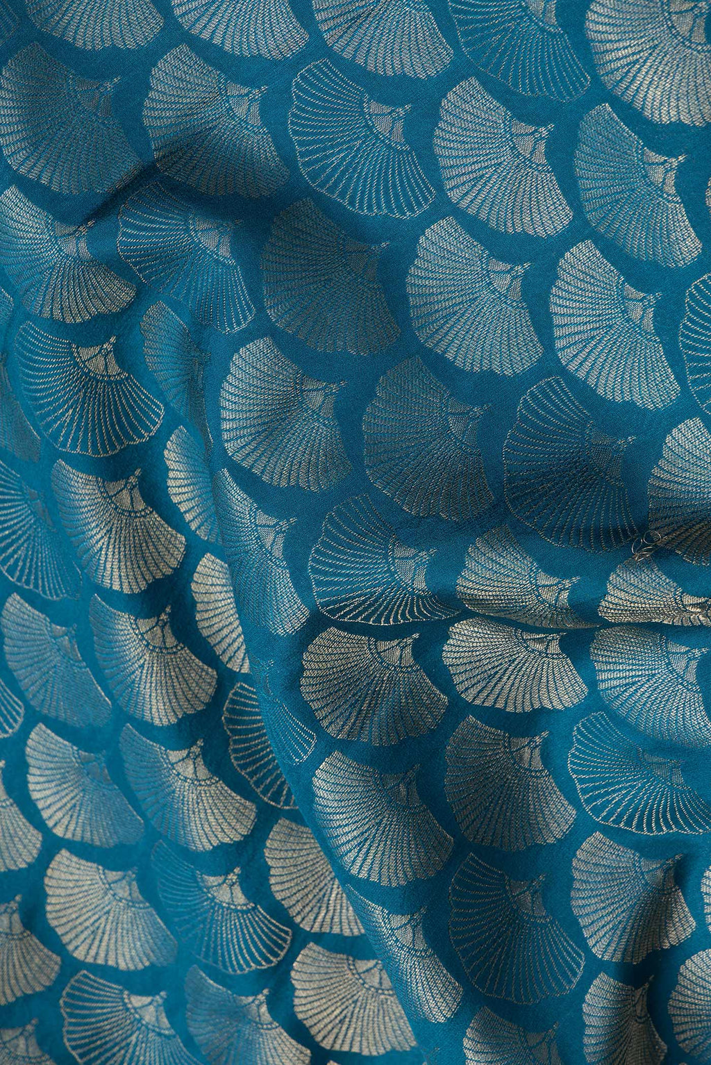 Close up of Peacock Blue Dual Tone Tussar Silk Saree with Zari Brocade on the body and Zari Border.  displaying folds