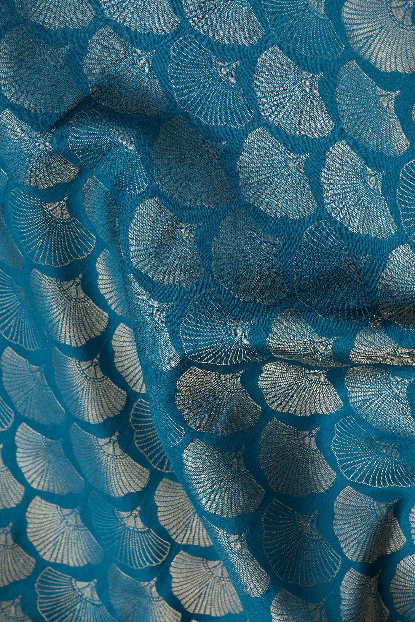 Close up of Peacock Blue Dual Tone Tussar Silk Saree with Zari Brocade on the body and Zari Border.  displaying folds