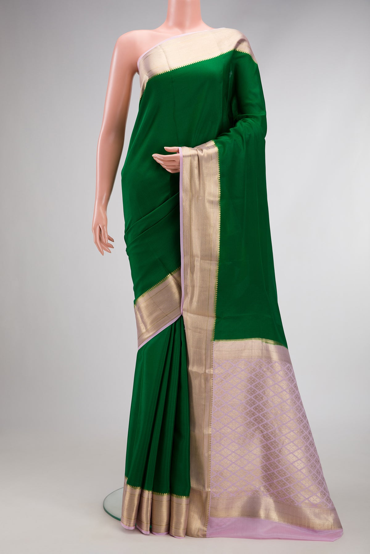 Bottle Green Mysore Crepe Saree with Plain Body and Zari Border.  displayed on a mannequin