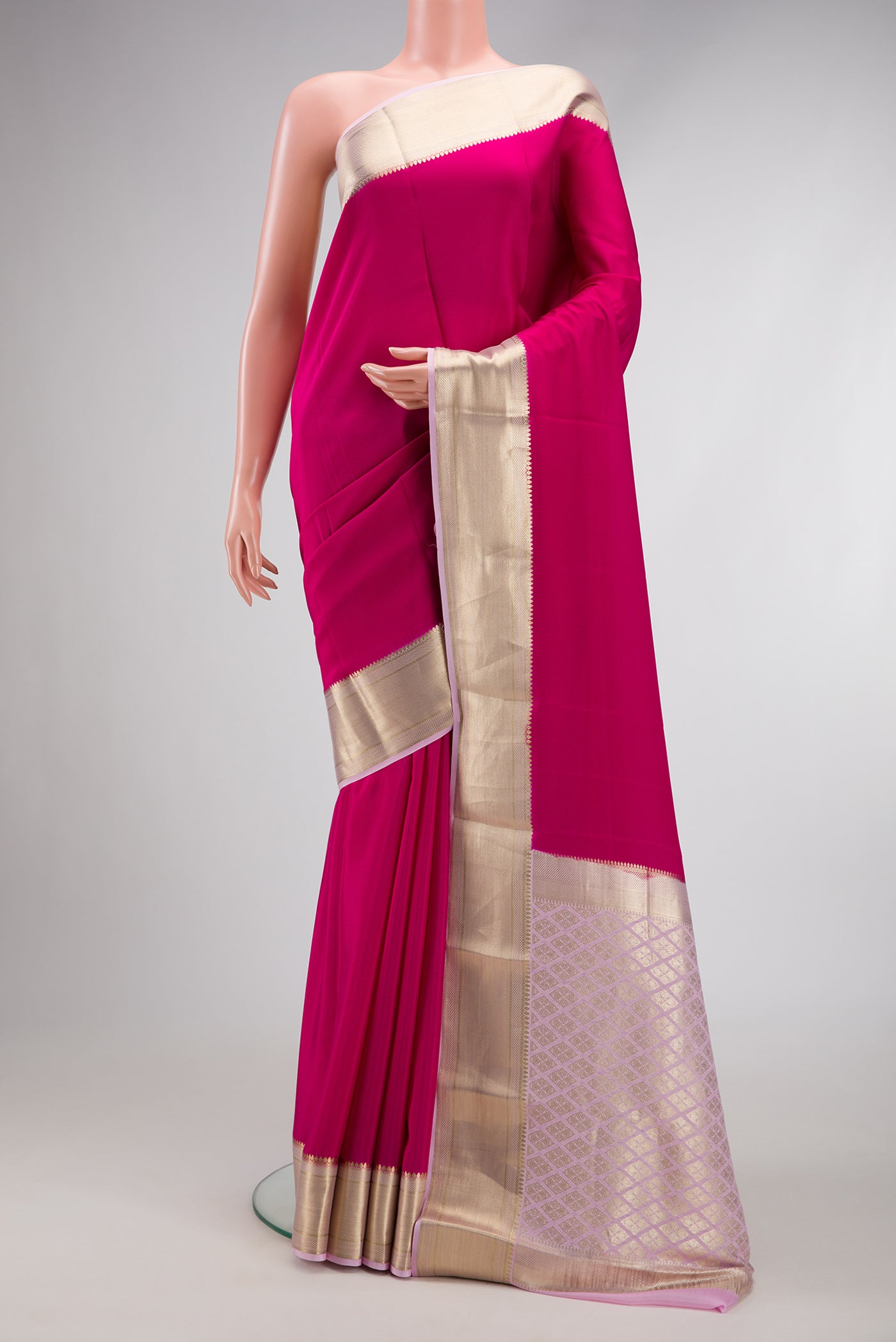 Dark Pink Mysore Crepe Saree with Plain Body and Zari Border.  displayed on a mannequin
