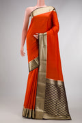 Orange Mysore Crepe Saree with Plain Body and Zari Border.  displayed on a mannequin