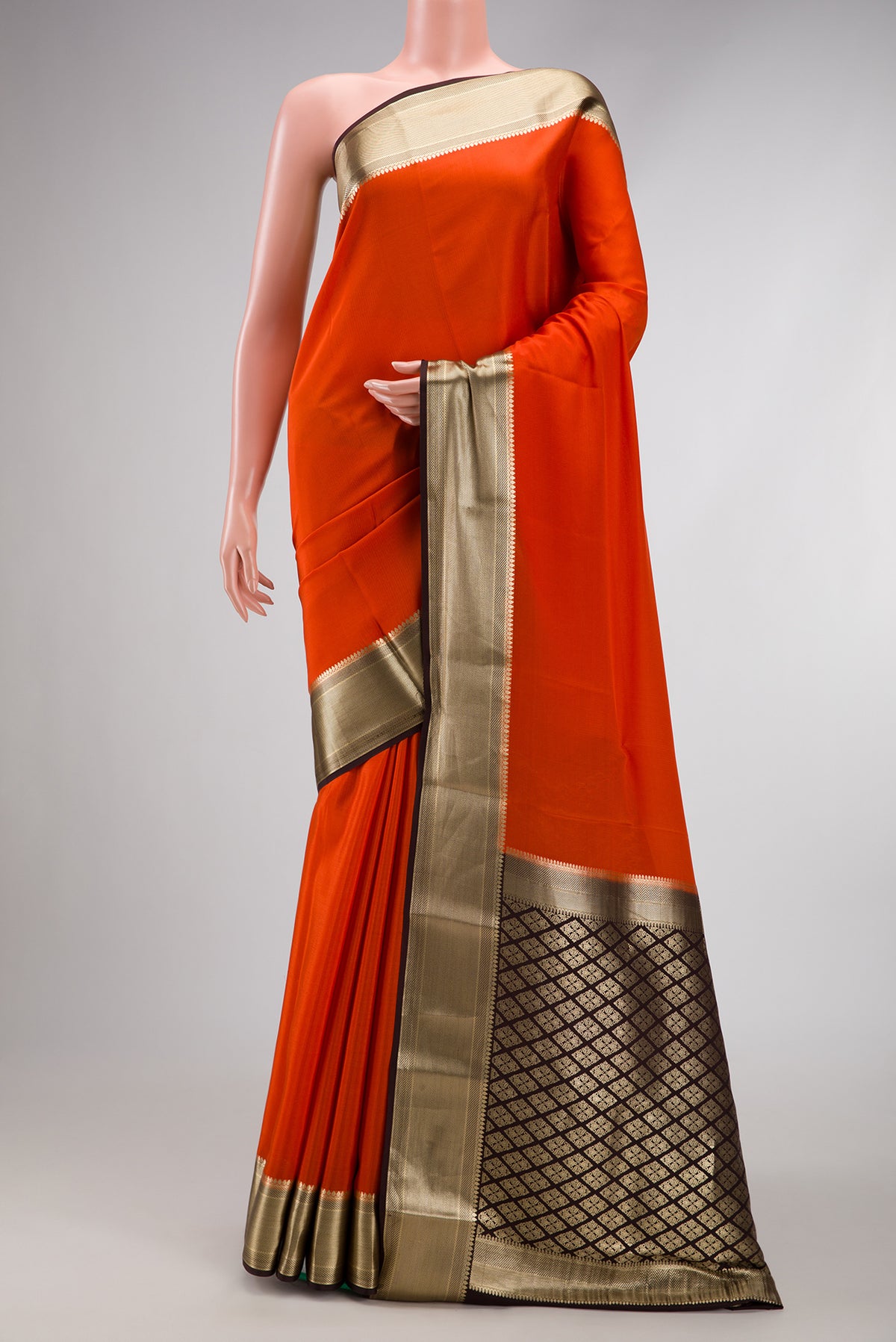 Orange Mysore Crepe Saree with Plain Body and Zari Border.  displayed on a mannequin